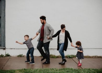 family-of-four-walking-at-the-street-2253879